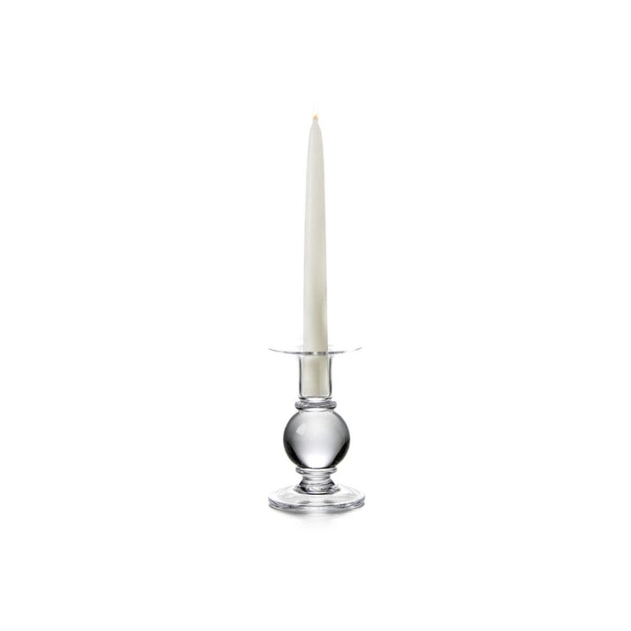 Clear glass candlestick with spherical base holding a tall tapered cream candle.