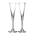 Two clear glass champagne flutes with tapered bowls and decorative stem bases.
