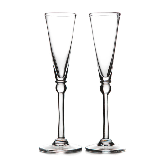 Two clear glass champagne flutes with tapered bowls and decorative stem bases.