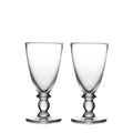 Two clear glass water glasses with decorative pedestal bases and wide bowls.