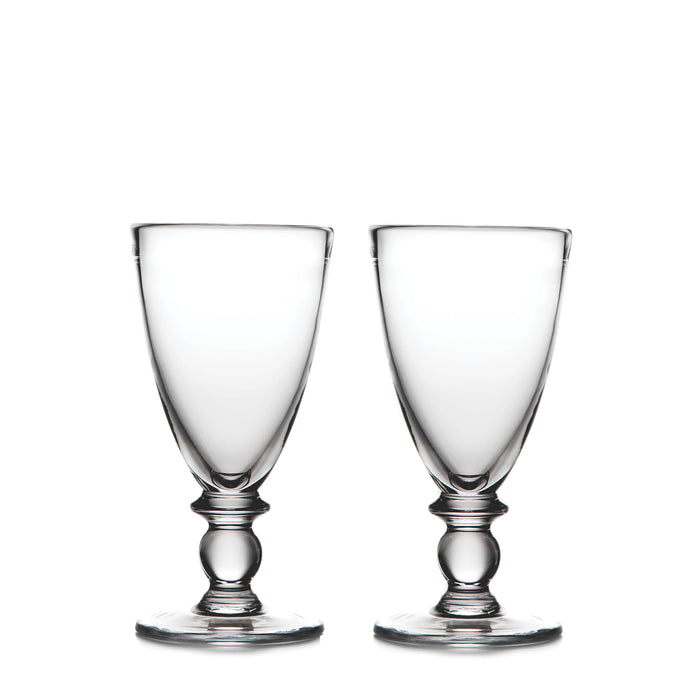Two clear glass water glasses with decorative pedestal bases and wide bowls.