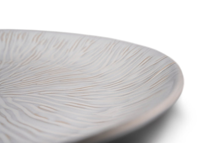 White oval platter with textured linear pattern across the surface.