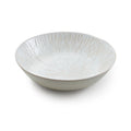 White ceramic serving bowl with radial line texture pattern throughout interior and exterior.
