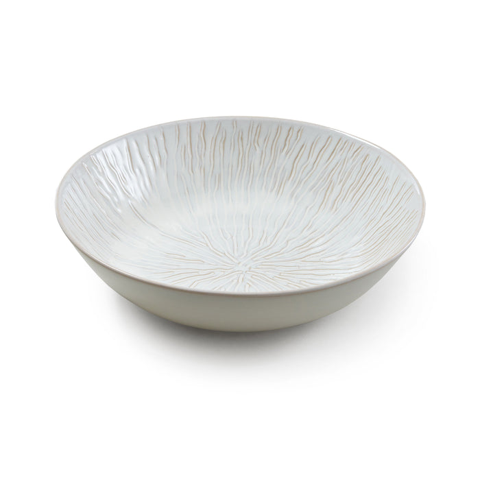 White ceramic serving bowl with radial line texture pattern throughout interior and exterior.
