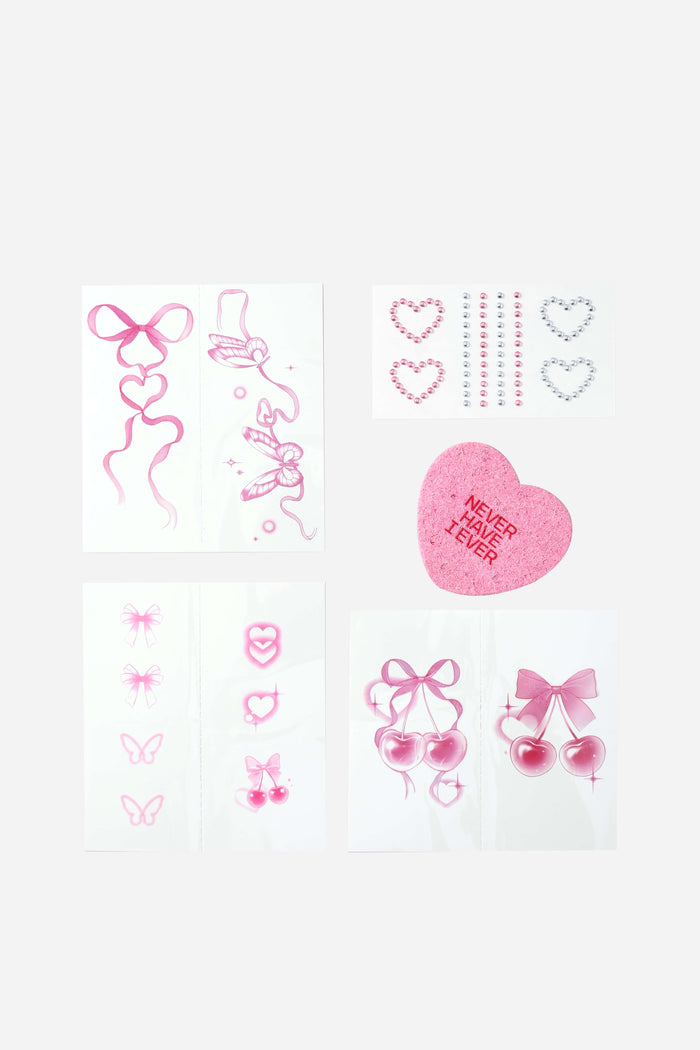 Pink temporary tattoos: bows, hearts, butterflies, cherries. Includes 'Never Have I Ever' heart sticker and rhinestones.