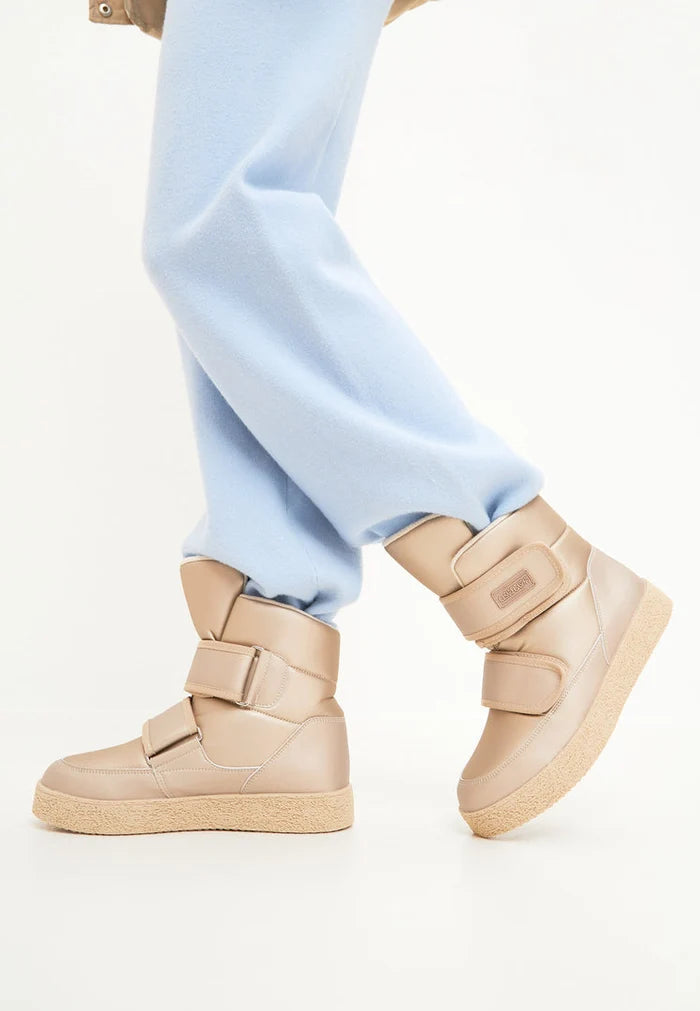 Stay warm and stylish this winter with beige high-top boots featuring Velcro straps - the perfect winter footwear for cold weather outings.