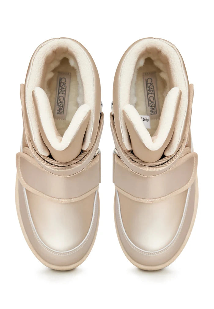 A pair of beige high-top winter boots with velcro straps, perfect for stylish and warm winter footwear.