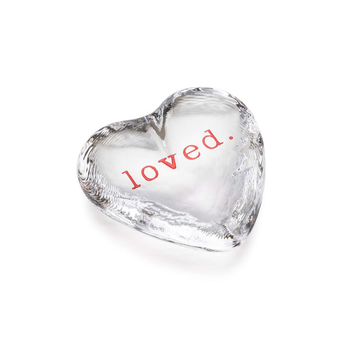 Clear glass heart with red "loved" text printed on front surface.