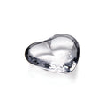 Clear glass heart-shaped object with smooth, rounded surfaces and light reflections.