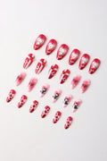 Kewpie cat press-on nails with heart and checkerboard designs in pink and red