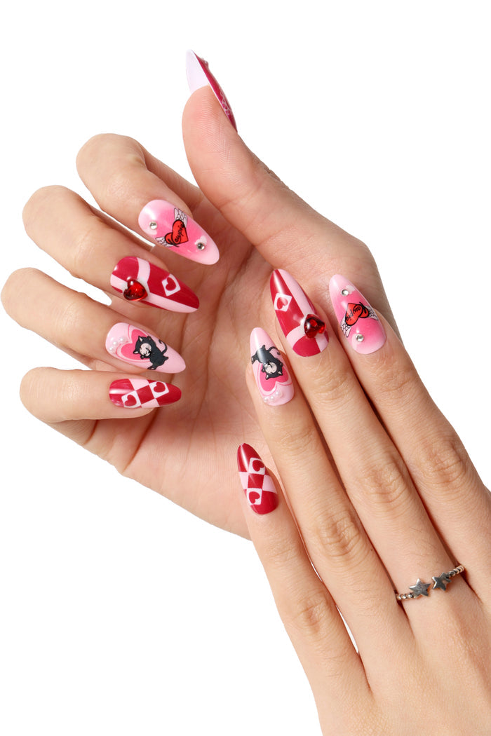 Kewpie Cat press-on nails with pink and red Valentine's designs, featuring hearts and a cat motif.