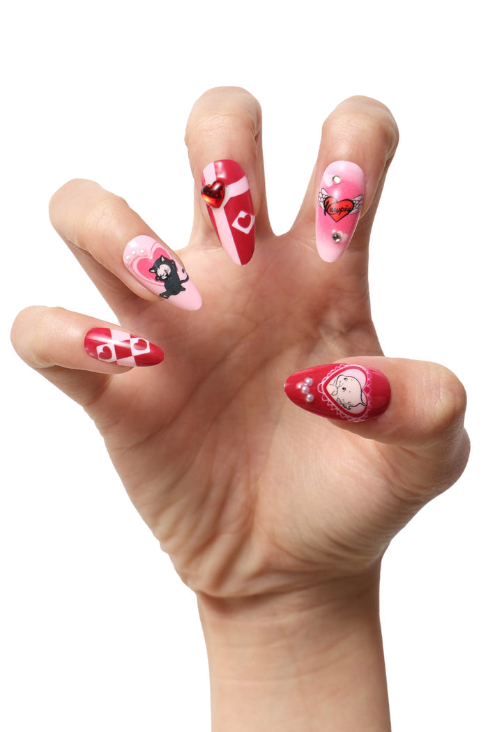 Kewpie Cat press-on nails with playful Valentine's designs: black cat, winged heart, and heart patterns.