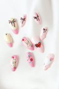 Kewpie Pastel press-on nails with baby, rose, and heart designs. Pastel pink and cream.