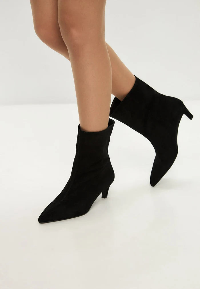 A stylish pair of black kitten heel ankle boots, perfect for women's fashion footwear, with a chic Dolly style design.