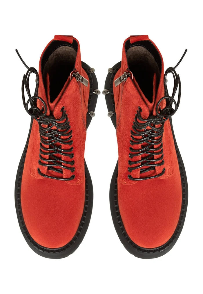 A pair of stylish red lace-up combat boots with a chunky sole, perfect for women's fashion.