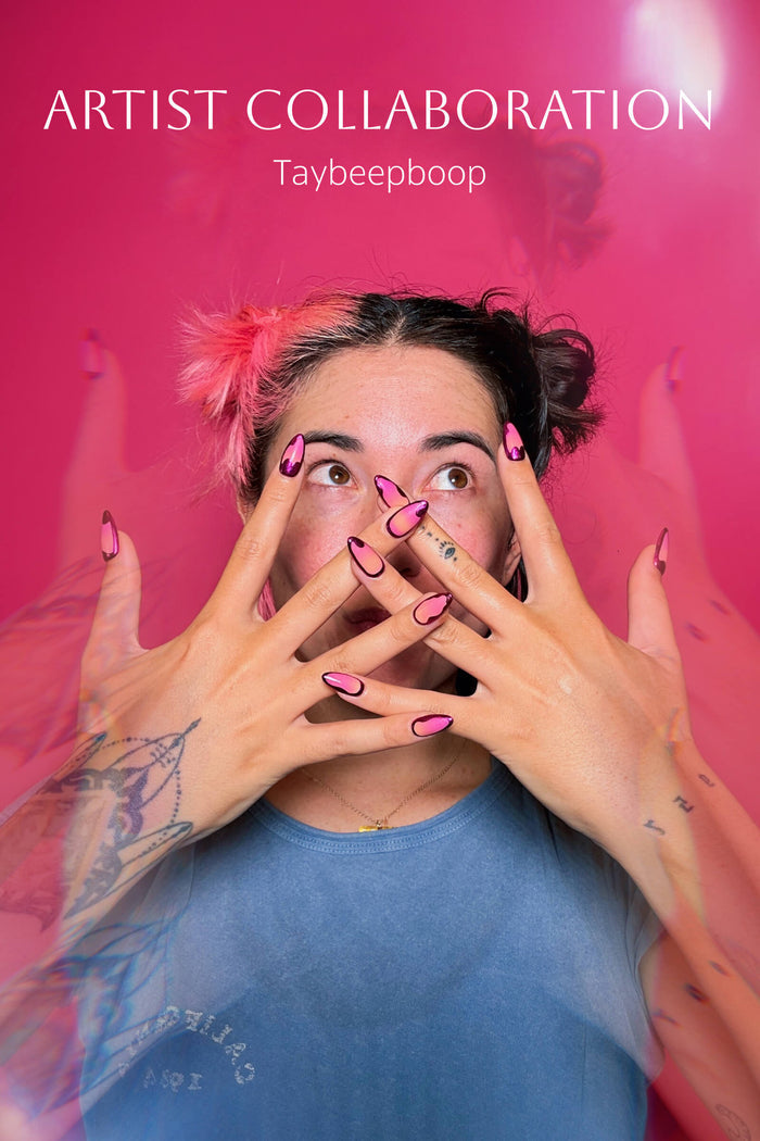 Woman with pink/black hair and ombre press-on nails, hands over face. Artist Collab Taybeepboop.