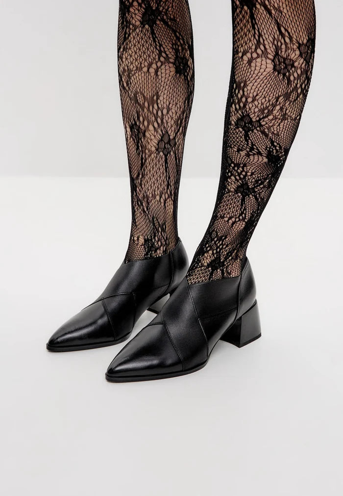 A stylish pair of high-quality leather block heel pumps, perfect for fashionable women looking for trendy footwear.