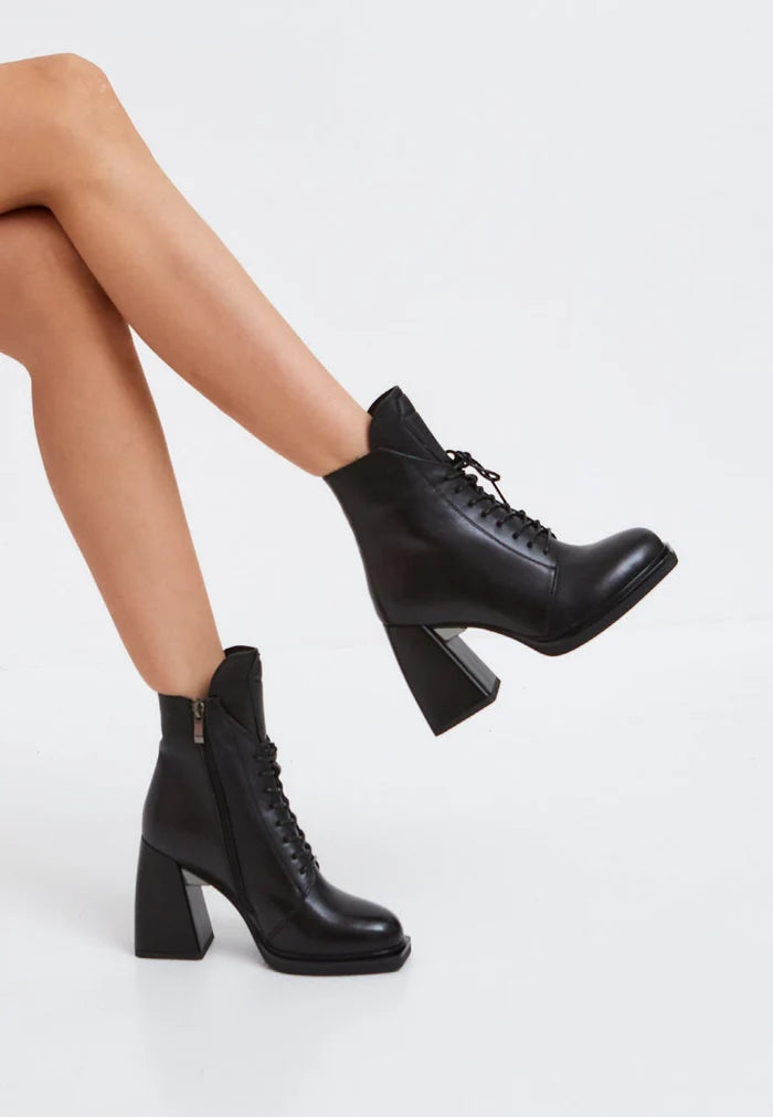 A stylish pair of leather lace-up ankle boots in black, also known as Behati boots, with a sleek and elegant design perfect for any outfit.