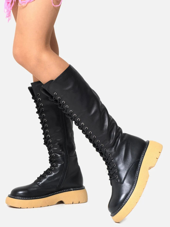 A pair of stylish black leather lace-up knee-high boots with a trendy lace-up design, perfect for adding a touch of edge to any outfit.