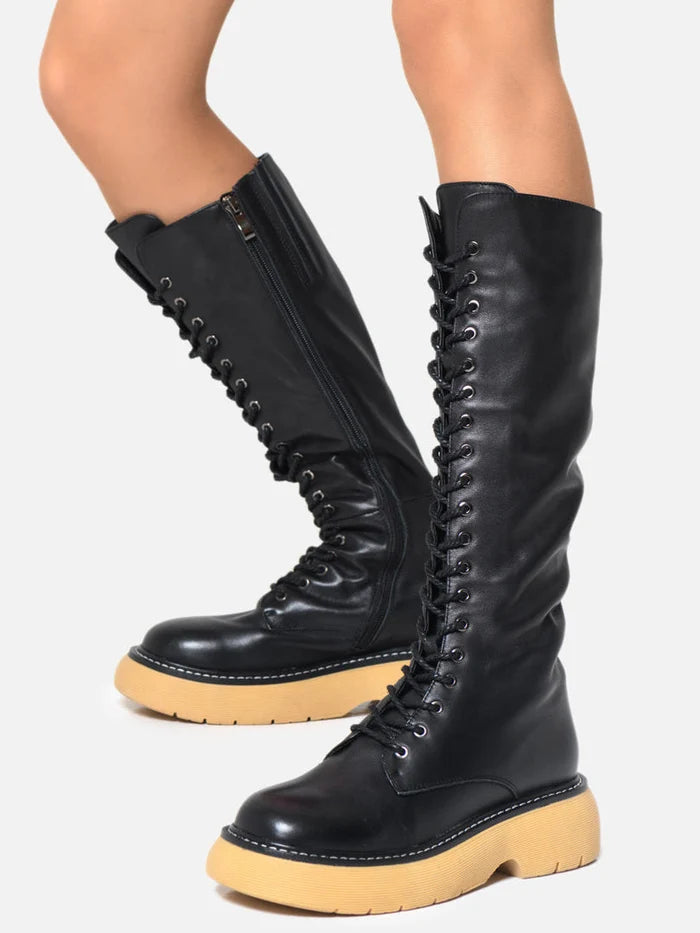 A stylish pair of knee-high leather lace-up boots for a trendy and sophisticated look.