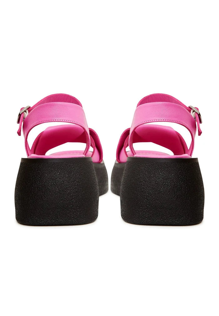 A stylish pair of designer fuchsia leather platform sandals with high heels for women.