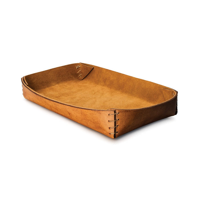 Tan leather tray with stitched seams and curved edges on white background.