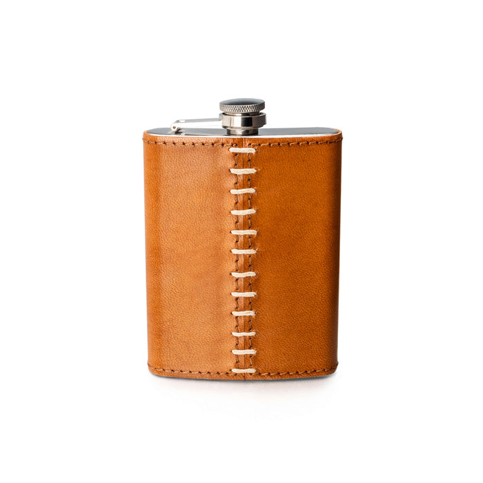 Stainless steel flask with tan leather wrap and white stitching detail down the center.