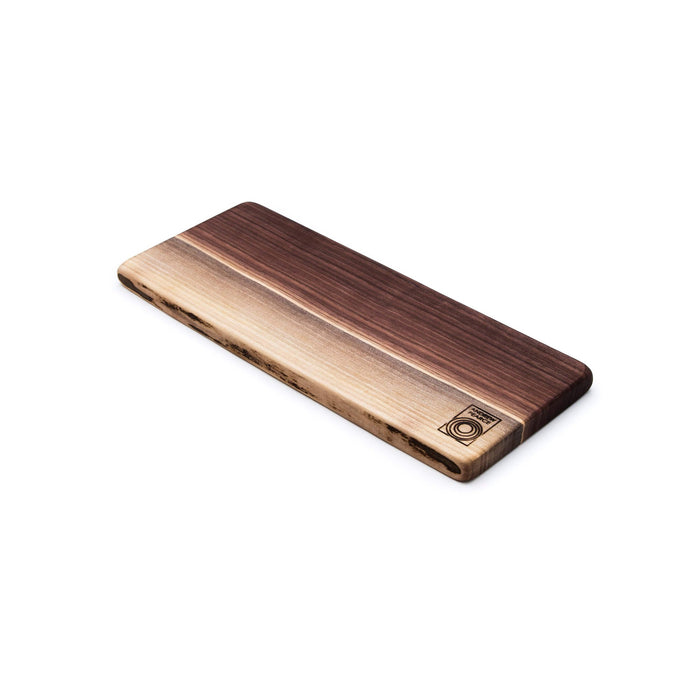 Black walnut wood board with live edge and natural light wood grain, featuring a circular logo stamp on light-colored end sec