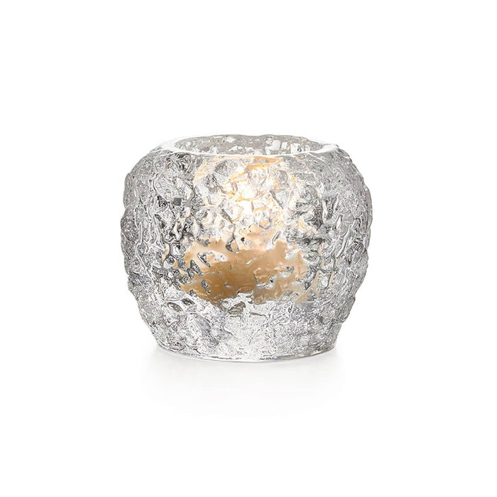 Silver textured tealight holder with lit candle visible inside.