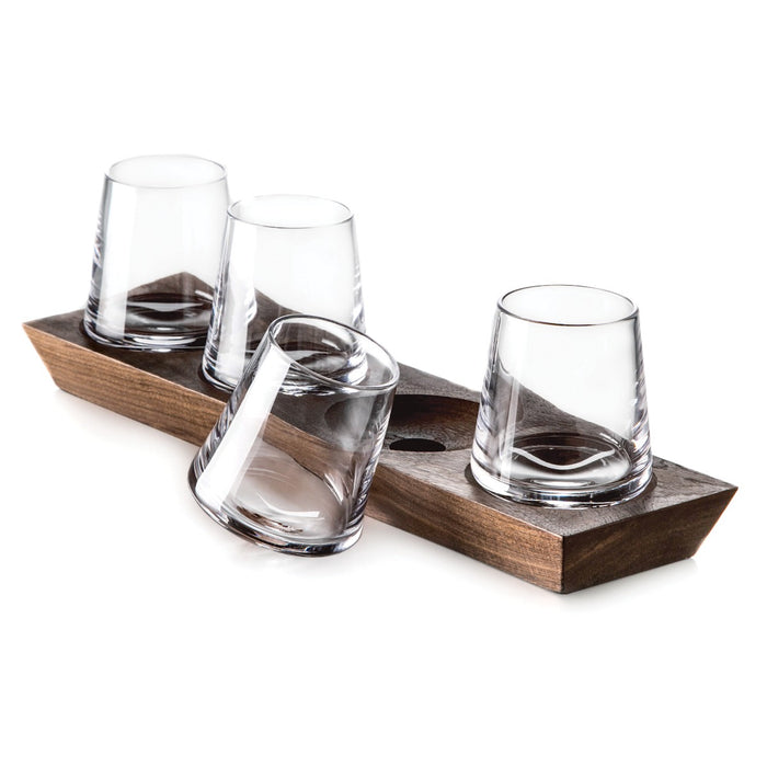 Four clear glass whiskey glasses with diagonal etching seated in a wood base tray.
