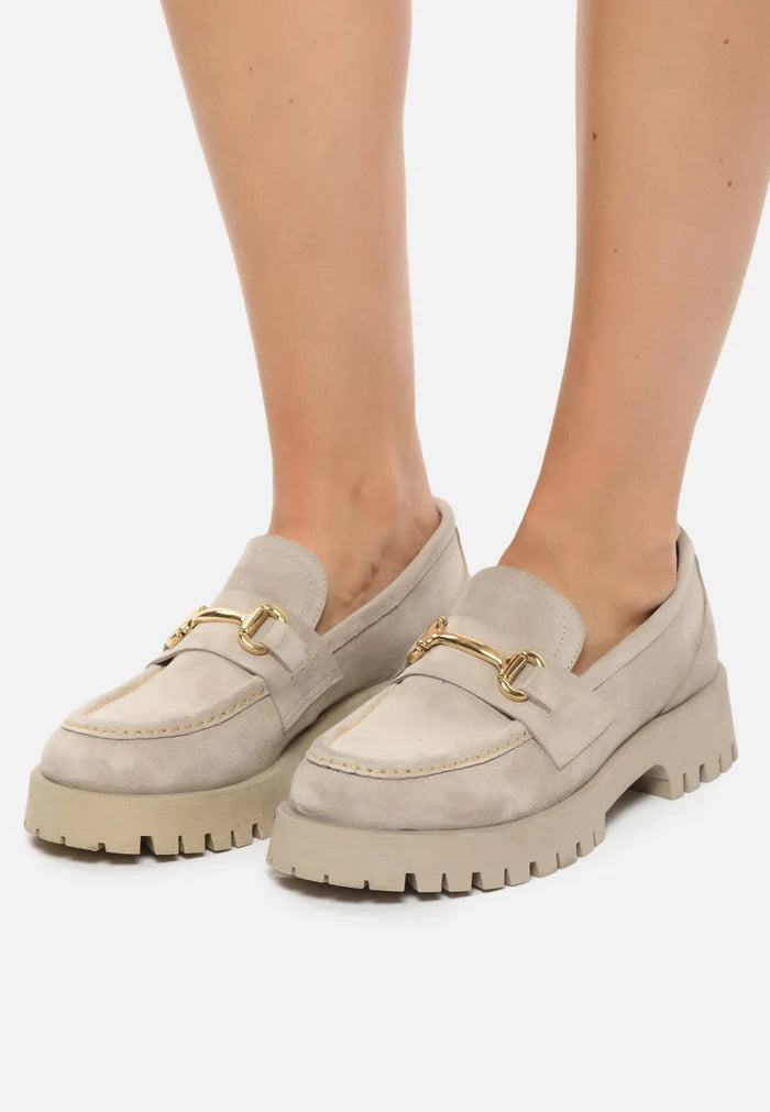 A stylish pair of luxe glide gold-bit loafers, also known as Josephine beige shoes, for women featuring designer details and luxury gold-bit adornments on beige leather slip-on shoes.