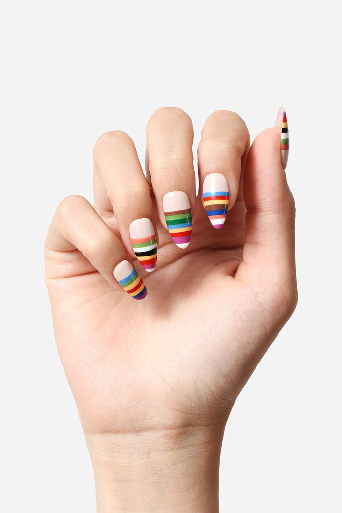Almond press-on nails with rainbow horizontal stripes.
