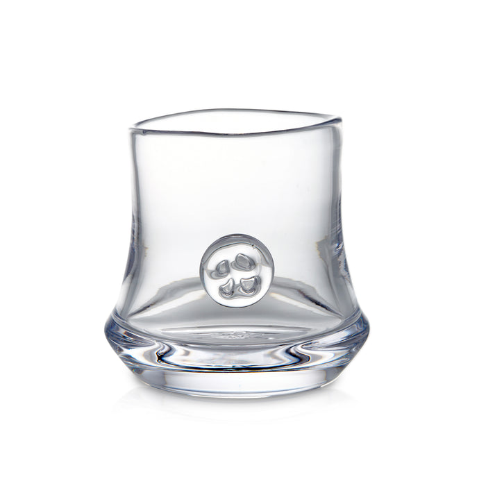 Clear glass tumbler with curved sides and circular emblem on front.