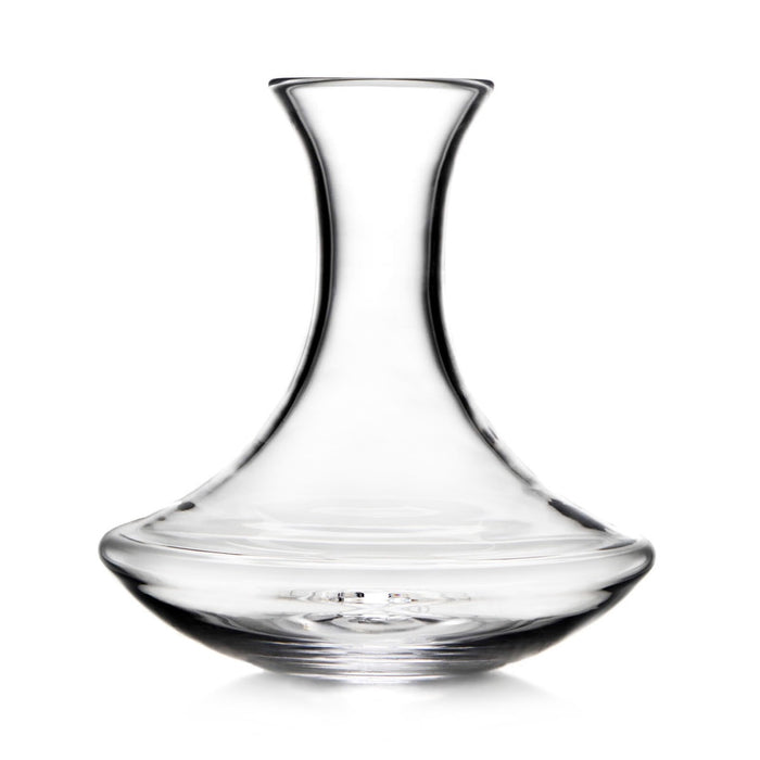 Clear glass wine decanter with curved hourglass shape and wide base.