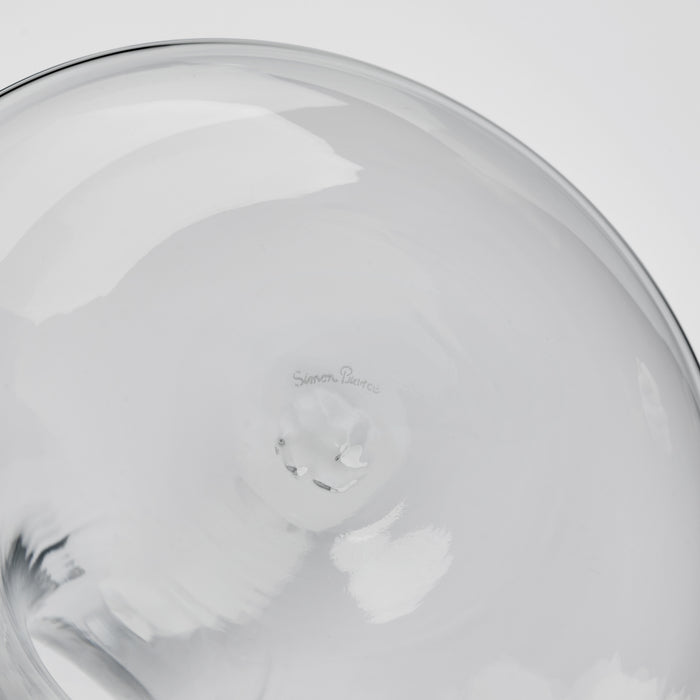 Clear glass decanter with curved body and maker's mark visible on interior base.