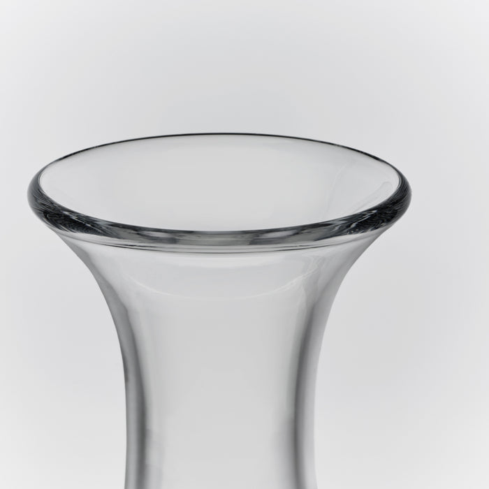 Clear glass wine decanter with wide flared rim and tapered cylindrical body.
