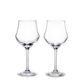 Two clear glass wine glasses with tulip-shaped bowls and long stems on white background.
