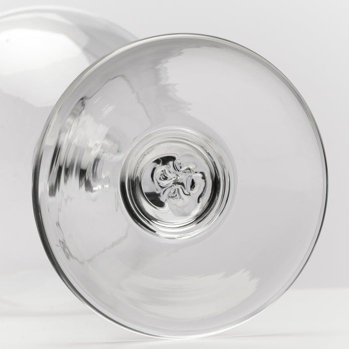 Two clear wine glasses with floral medallion detail on the base, shown from above.