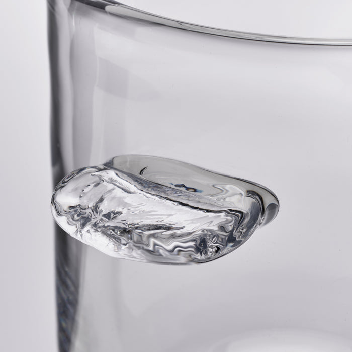 Clear glass ice bucket with organic curved rim and marbled interior pattern.