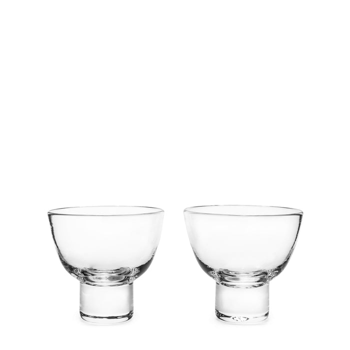 Two clear glass martini glasses with rounded bowls and short stems, displayed side by side.