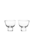 Two clear glass martini glasses with rounded bowls and short stems, displayed side by side.