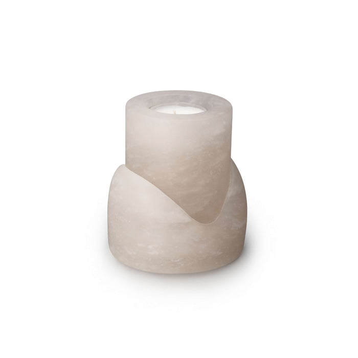 Cream-colored concrete candle holder with cylindrical upper cup and wider lower base with curved slot detail.
