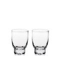 Two clear glass tumblers with thick bases displayed side by side.