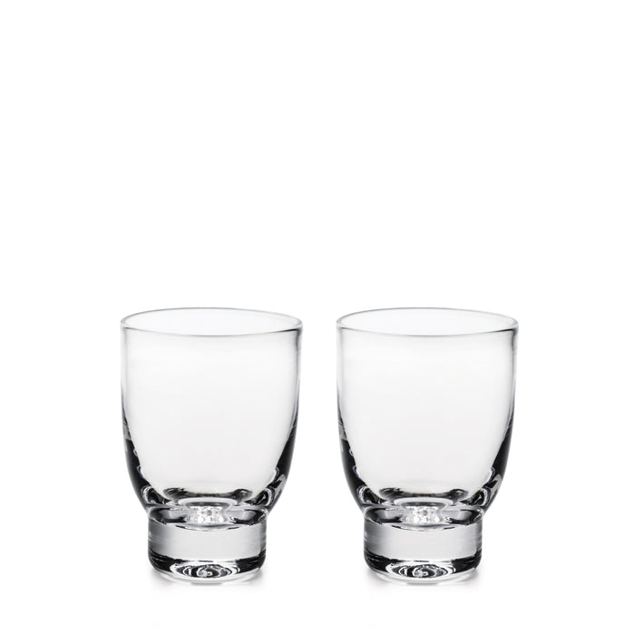Two clear glass tumblers with thick bases displayed side by side.