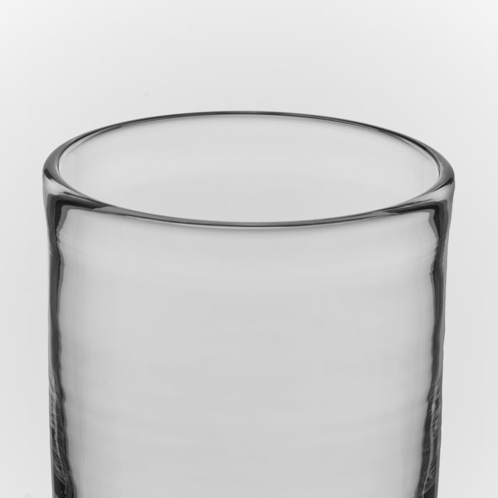 Clear glass tumbler with thick rim and cylindrical shape.