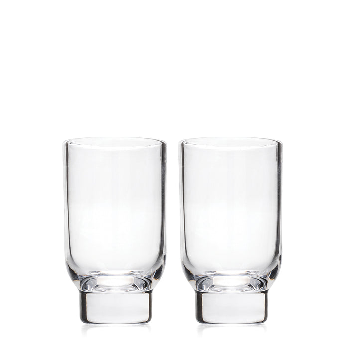 Two clear glass tumblers with thick bases displayed side by side.