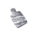 Grey marble board with veined pattern and rounded handle on top.