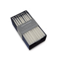Box of 45 ivory menorah candles by Simon Pearce, cylindrical tapered design.
