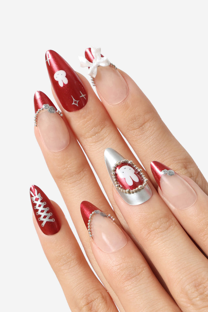 Burgundy almond press-on nails featuring Miffy character, white bow, silver bead accents, and lace-up design.