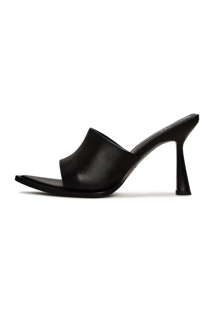 A pair of black minimalist heeled mules for women, a stylish choice in minimalist footwear.